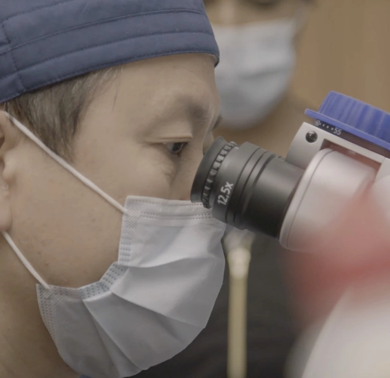 Dr. Paul C Lee looking into a equipment