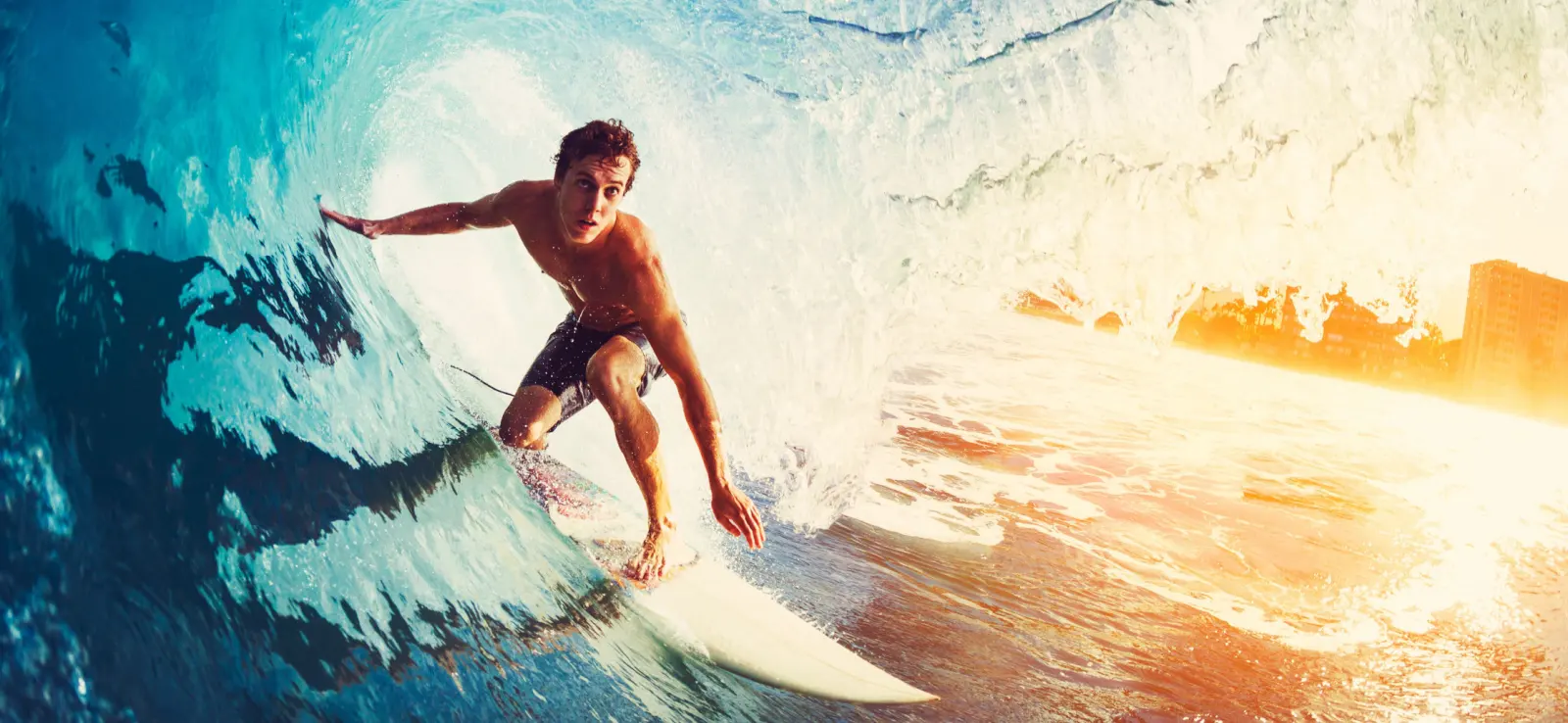 young healthy person surfer riding a big wave