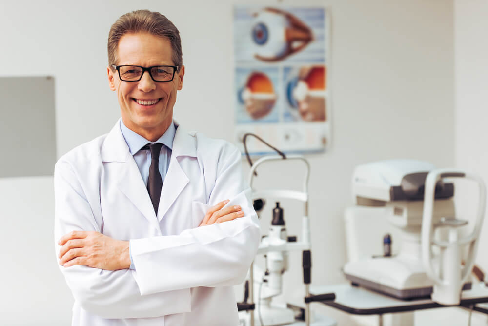 Middle Aged Ophthalmologist Looking at Camera and Smiling