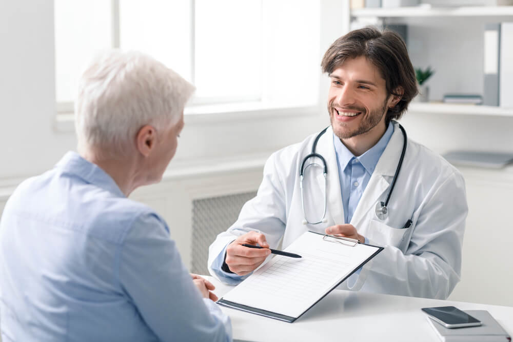 Doctor Explaining Prescription for Senior Female Patient at Clinic