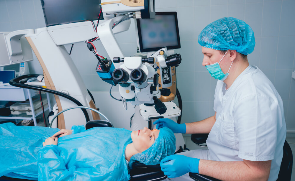 Doctor Working on Patient Under Surgical Microscope