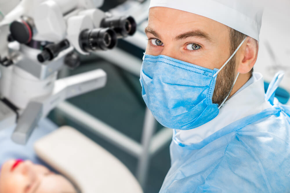 Eye Surgeon Working Near the Microscope in the Operating Room