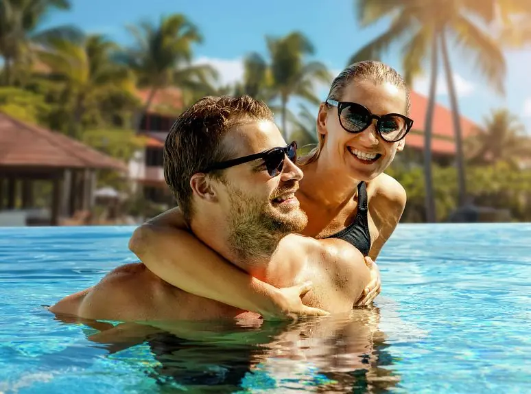 Couple swimming at a resort